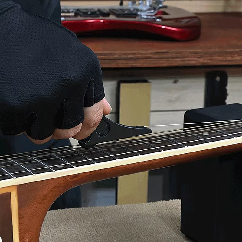 Guitar String Stretcher Photographed in use in a guitar workshop.