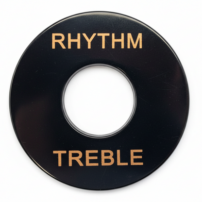 Close-up of a Guitar Toggle Switch /Pick Up Selector Surround Plate in black with gold text on a grey background.
