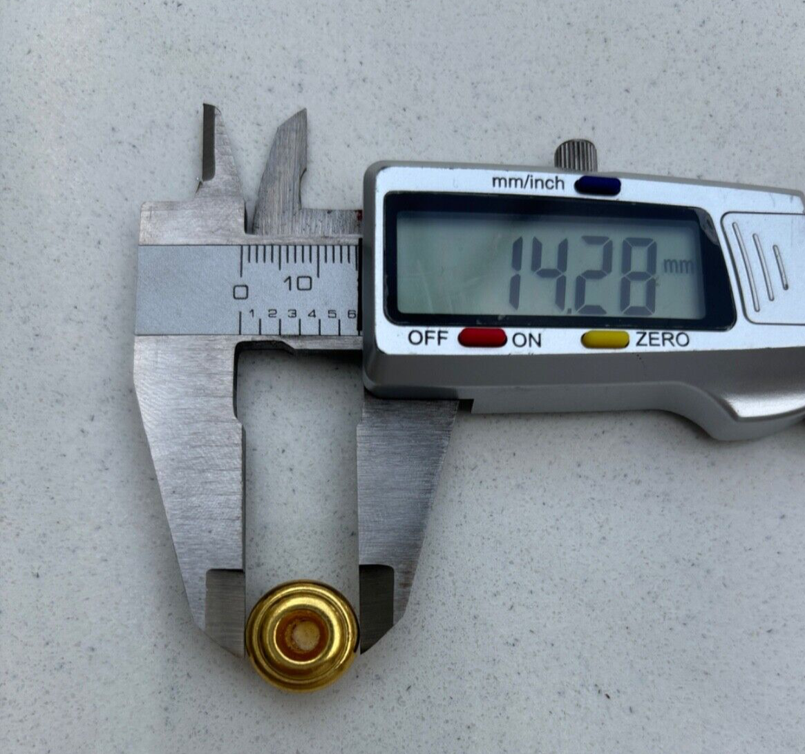 Digital caliper measuring a Mushroom Guitar Strap Button on a grey surface.