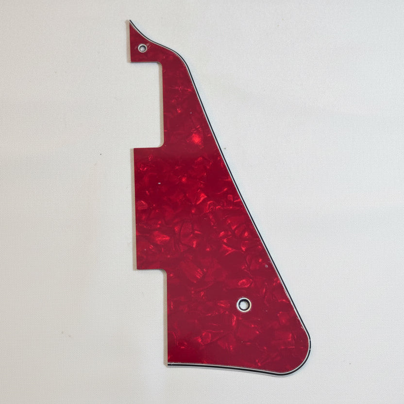 Red pearl electric guitar pickguard, LP-compatible, on a white surface.