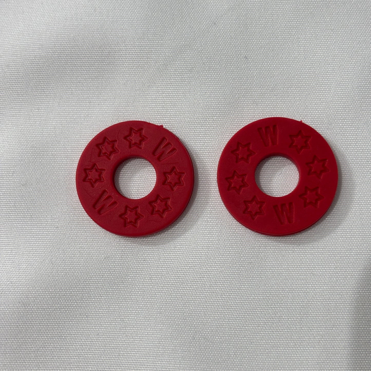 Two Red Rubber Guitar Strap Locks on a light grey background.