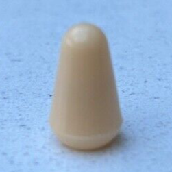 Beige cone-shaped object on a textured blue surface