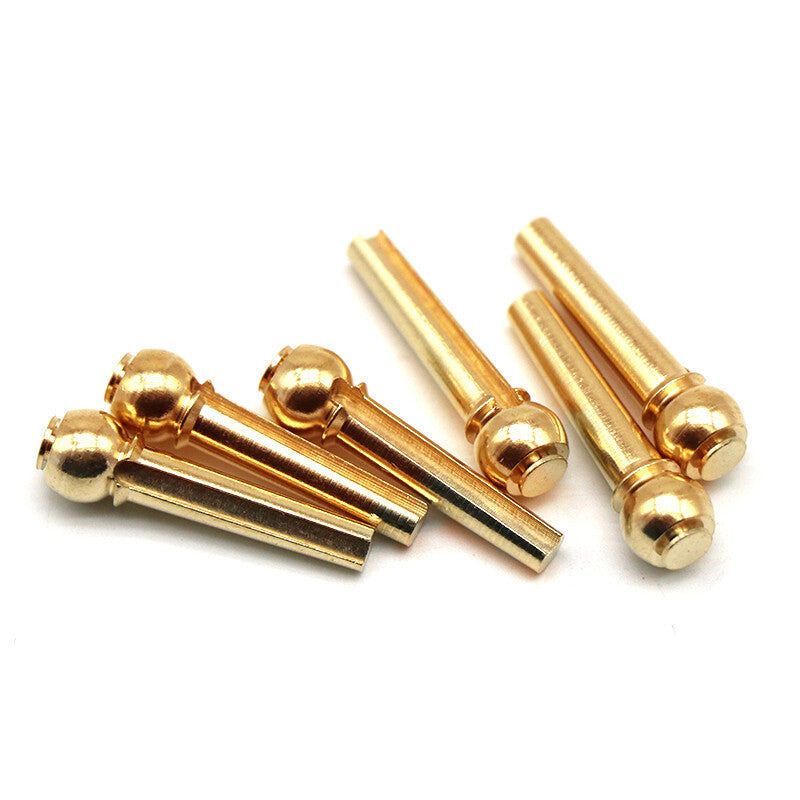 Six Acoustic Guitar Brass Bridge Pins on a white background