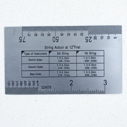 The back of a Steel Guitar Action gauge on a white background.