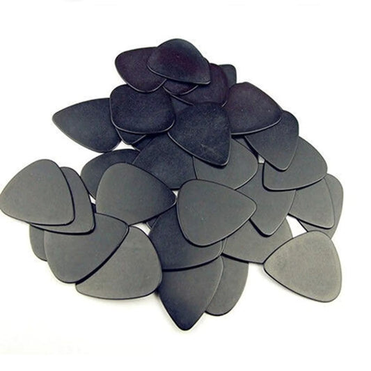 A number of Black Plectrums / Picks photographed on a white background.