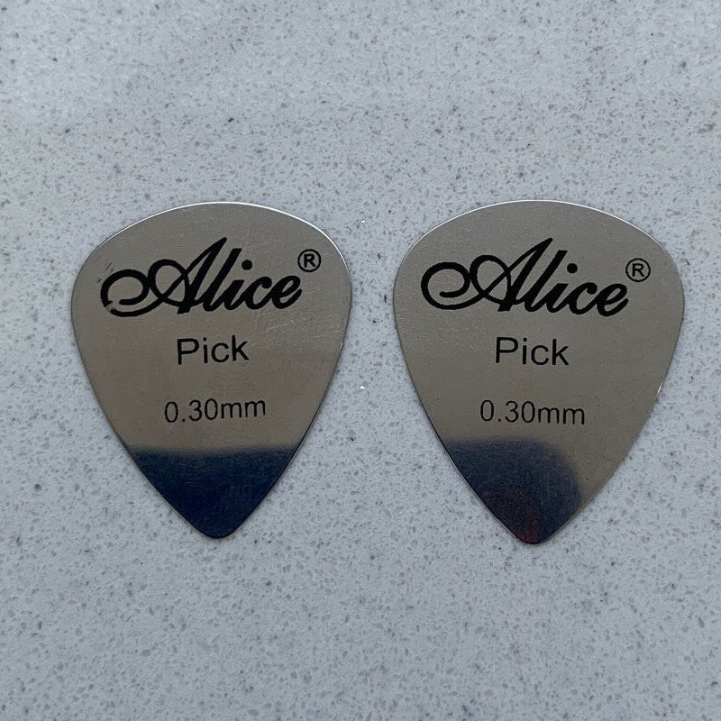 Two Alice Steel Guitar Picks Plectrums on a light grey background.