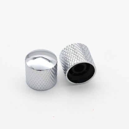 Two Chrome electric guitar control knobs on a white background.