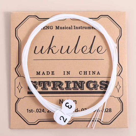 Ukulele strings on top of packaging on a beige background.