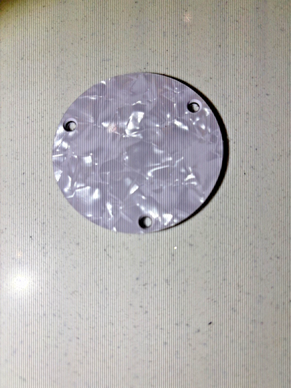 Electric Guitar Switch compartment cover in White Pearl on a grey surface.