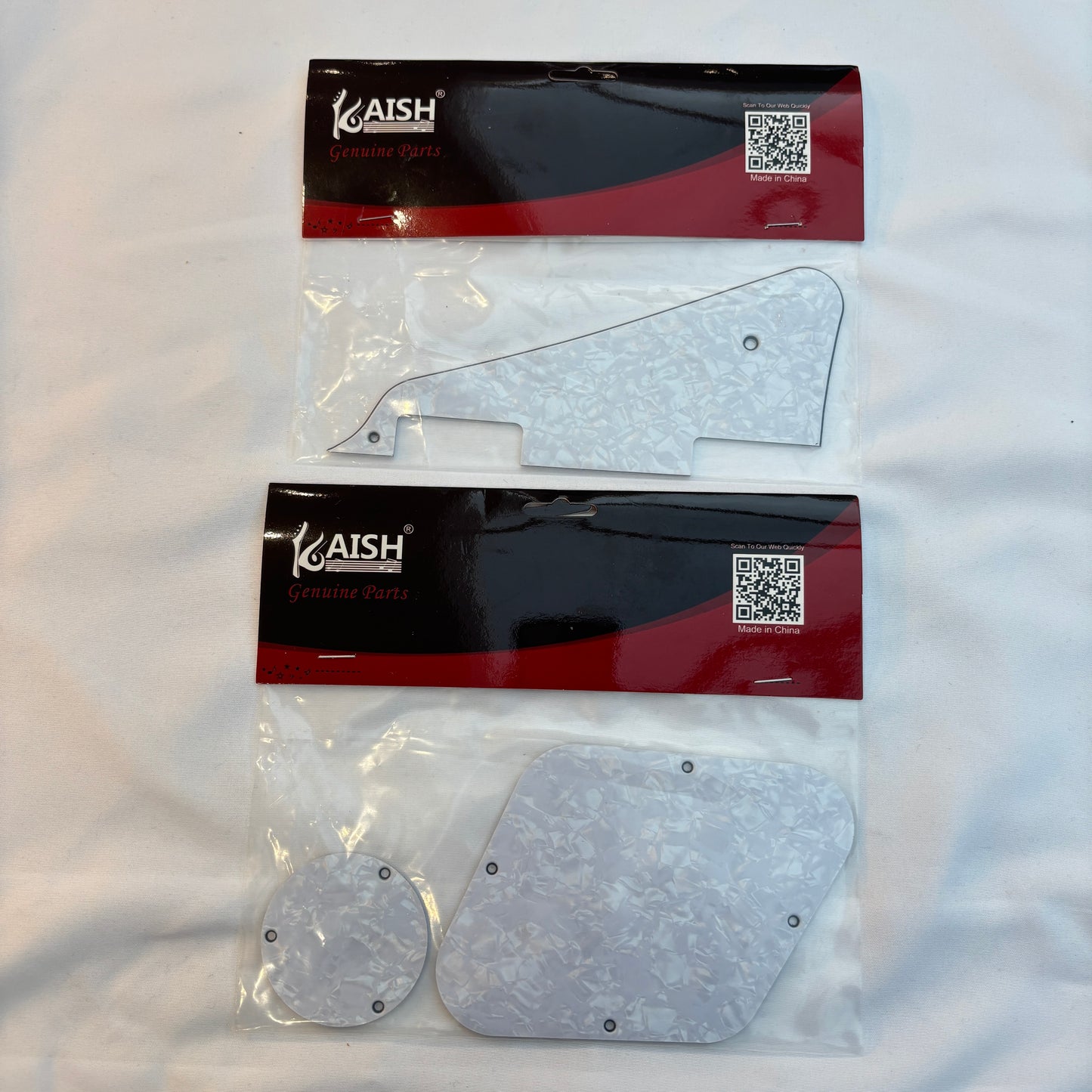 White pearl pickguard set, LP-compatible, on a white surface.